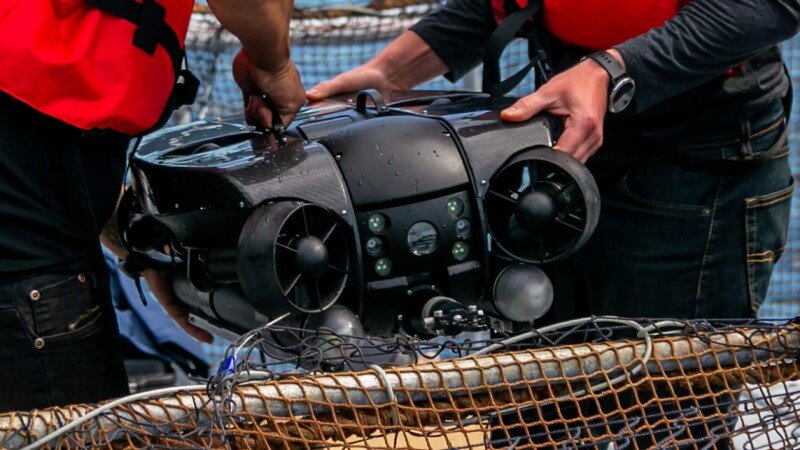 men handling remotely operated vehicle by Deep Trekker