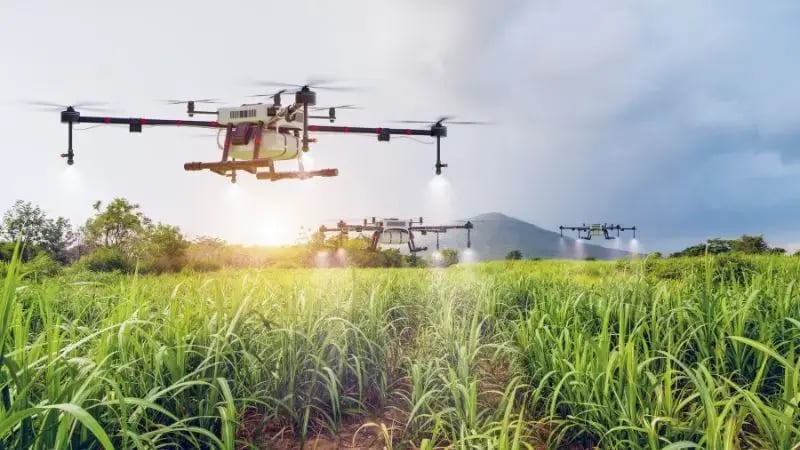 agriculture drone flying and spraying water